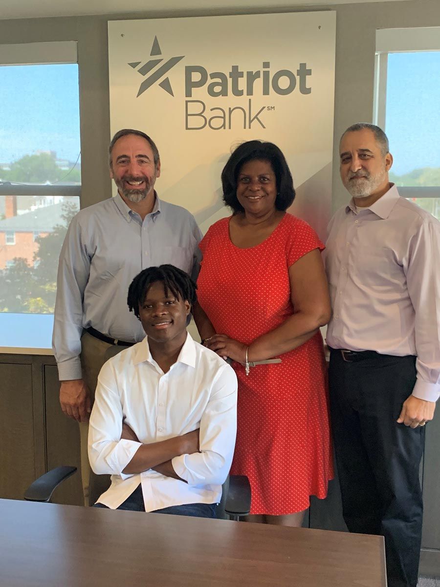 HCC Student Koffi Gnamien (seated), standing (l-r) Rob Russell, CEO and Bank President, Judith Corprew, EVP and Chief Risk, Compliance and CRA, and Steven Grunblatt, EVP and CIO.