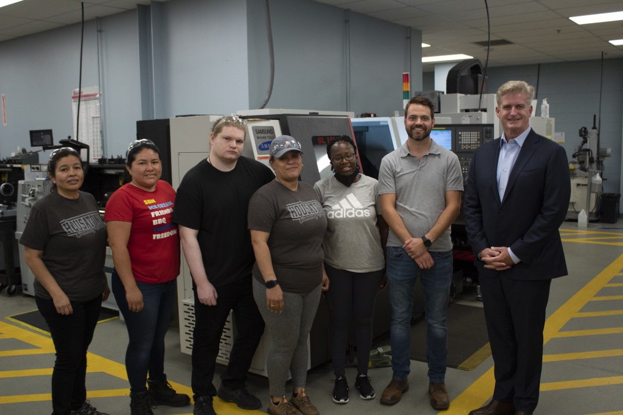 Far right: Bill Tommins, president, Bank of America Southern Connecticut, stands next to Adam Scobie, HCC Assistant Professor of Manufacturing Technology and a number of students in HCC’s Advanced Manufacturing program.